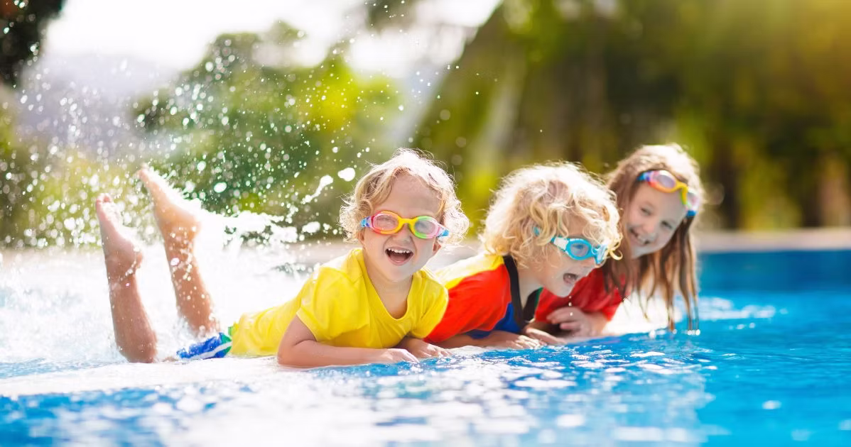 Family enjoying clean swimming pool maintained with regular pool maintenance in summer